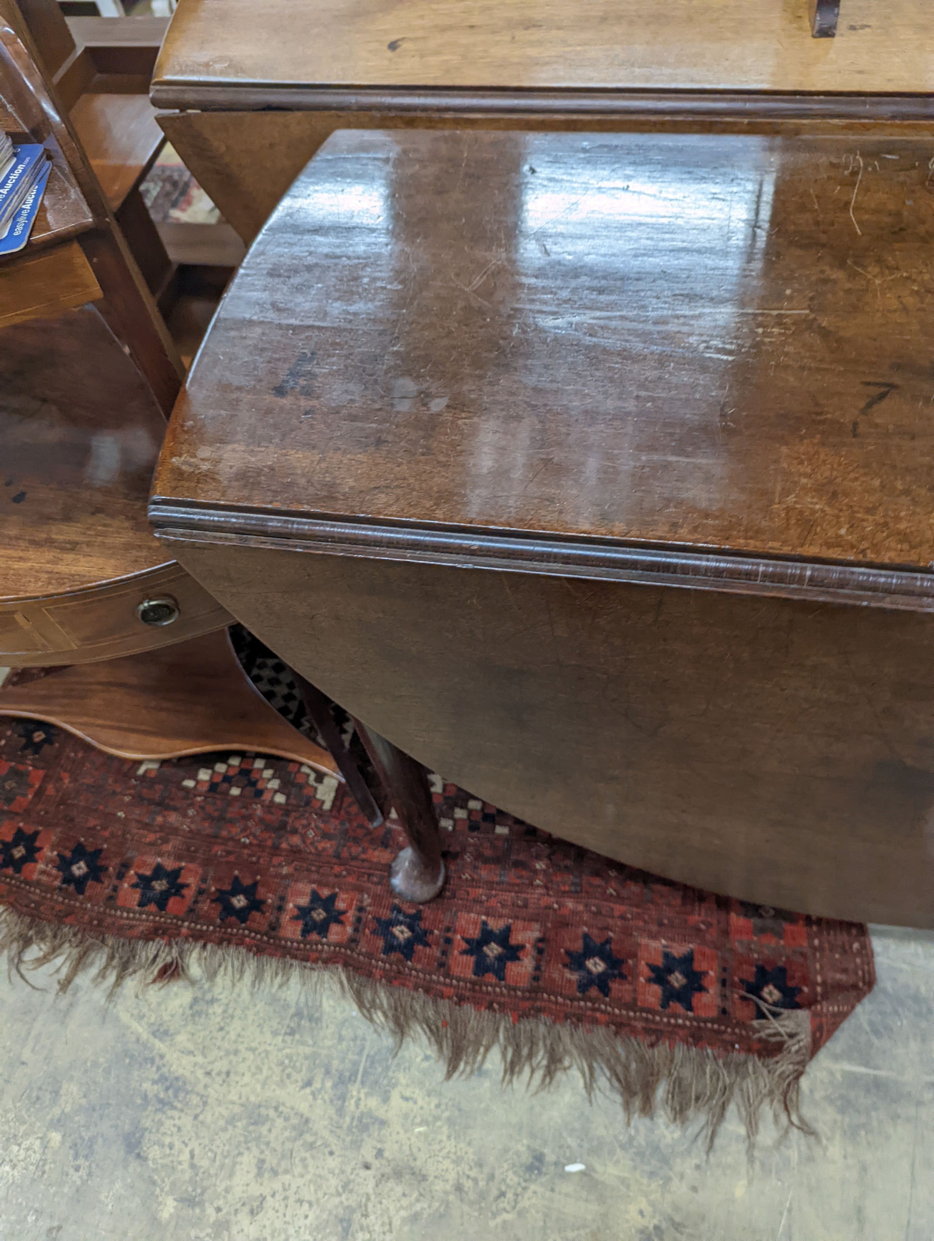 A George III oval mahogany drop leaf pad foot dining table, width 108cm, length 134cm extended, height 70cm